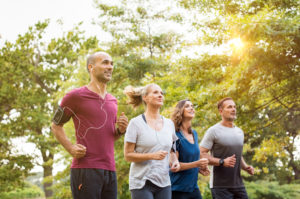 Workplace running group on lunch-time training run together. Representing wellbeing at work.