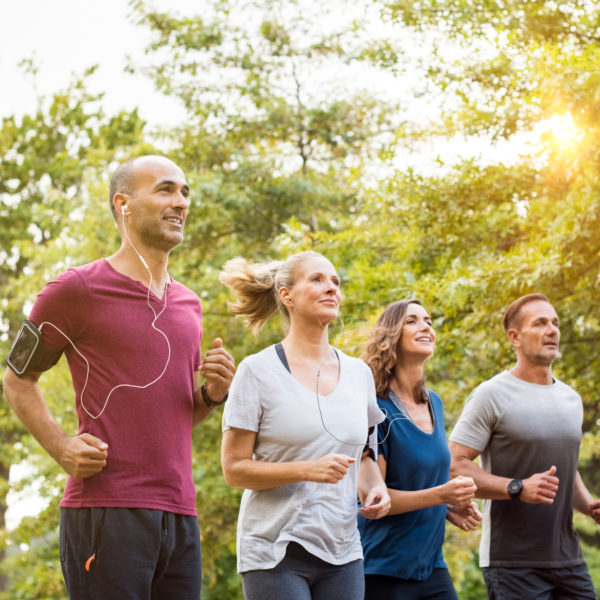 Workplace running group on lunch-time training run together. Representing wellbeing at work.