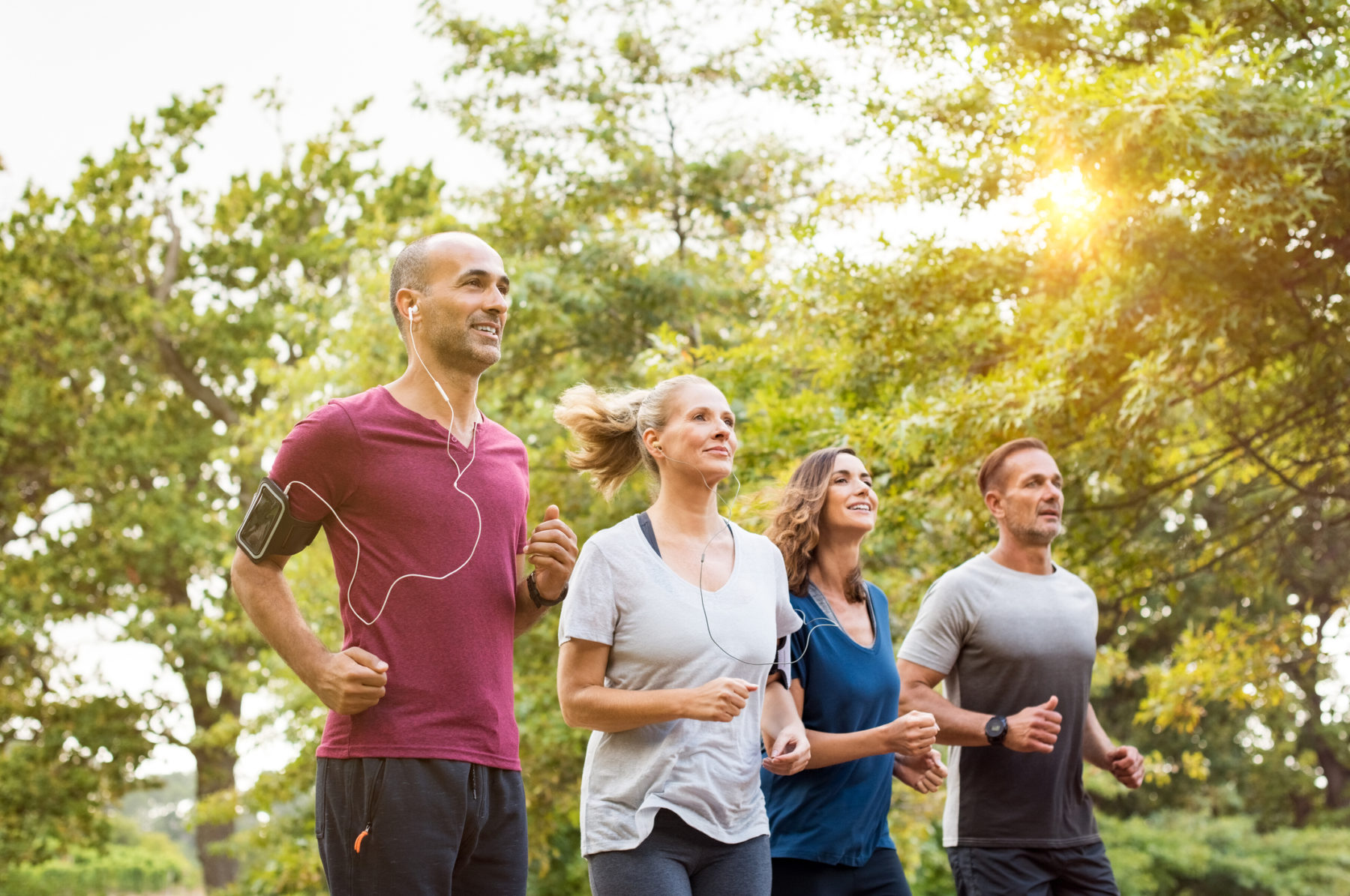 Workplace running group on lunch-time training run together. Representing wellbeing at work/ health and wellbeing in the workplace