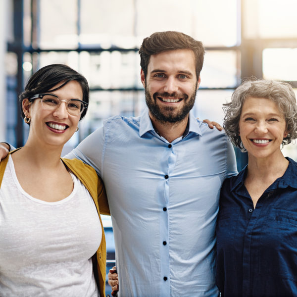 A work team standing together in a modern office - demonstrating a professional code of ethics