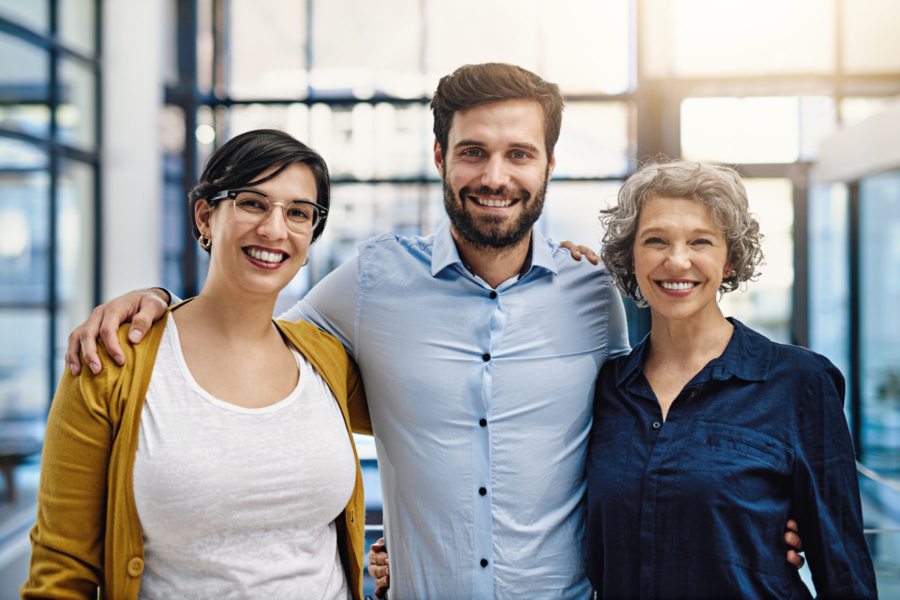 A work team standing together in a modern office - demonstrating a professional code of ethics