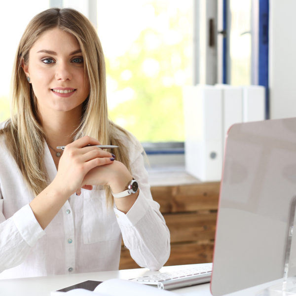 An executive assistant at her computer- representing 'goals of an executive assistant' concept