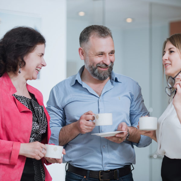 Wellbeing at work concept - colleagues enjoying a coffee break