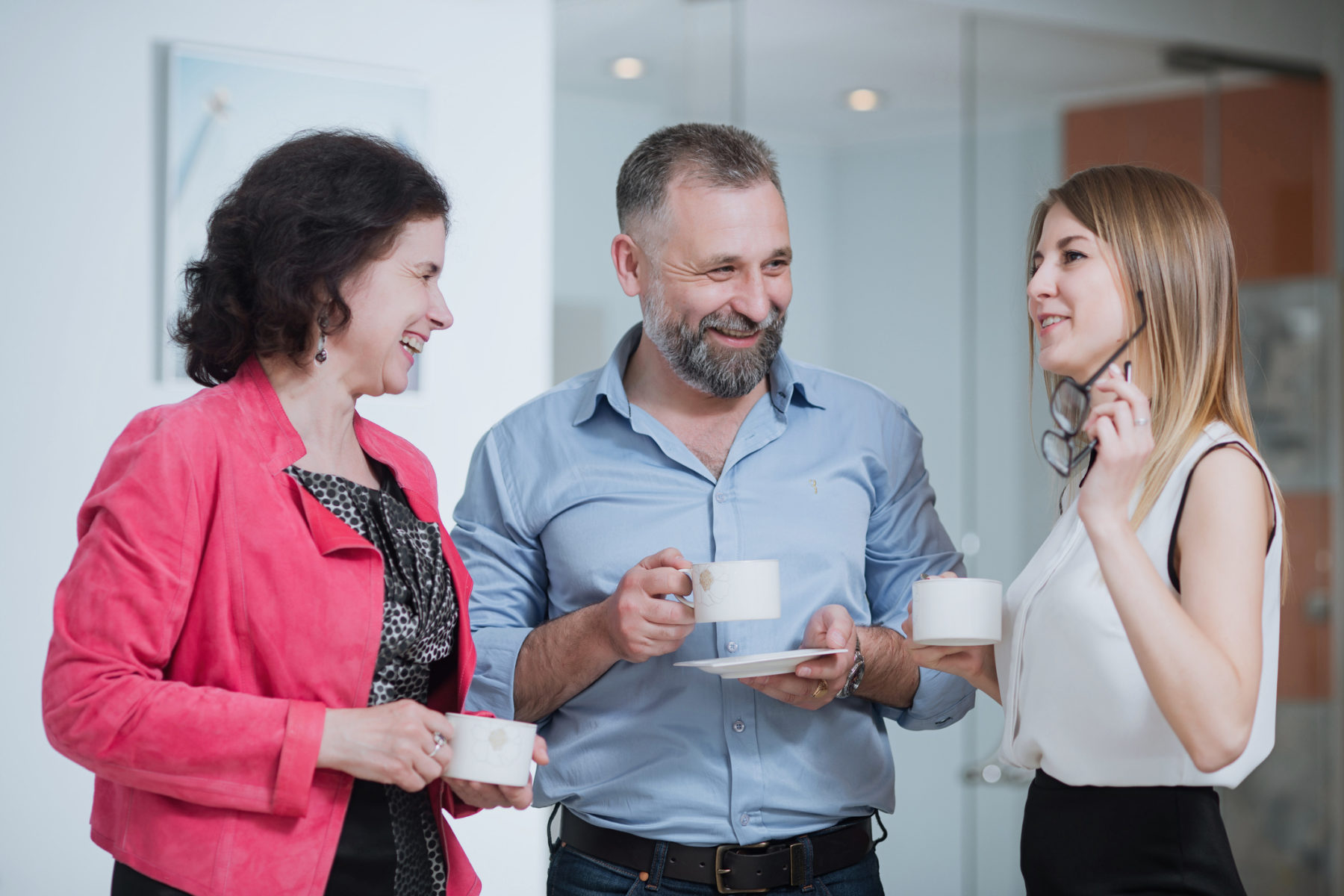 Wellbeing at work concept - colleagues enjoying a coffee break